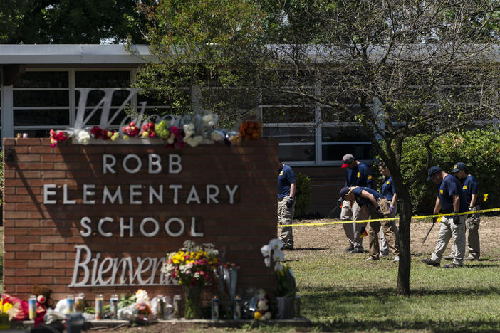 Investigators search for evidence outside Robb Elementary School in Uvalde, Texas, on Wednesday, the day after a mass shooting took place there.