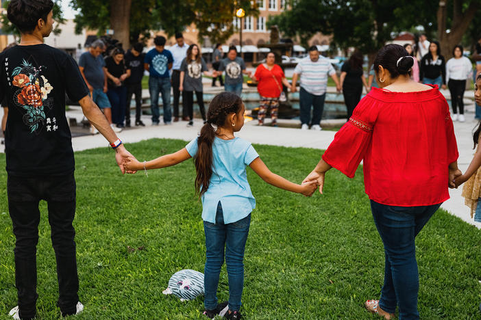 Members of the community gather at the City of Uvalde Town Square for a prayer vigil in the wake of a mass shooting at Robb Elementary School on Tuesday in Uvalde, Texas.