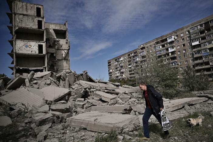 A man walks past a damaged building after a strike in Kramatorsk in the eastern Ukrainian region of Donbas, on Wednesday.