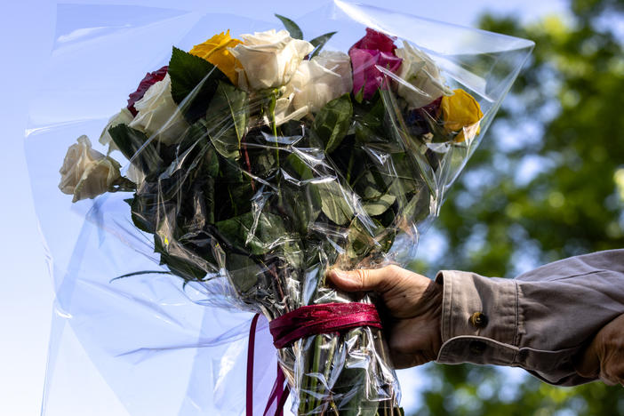 A man brings flowers to Robb Elementary School on Wednesday in Uvalde, Texas.