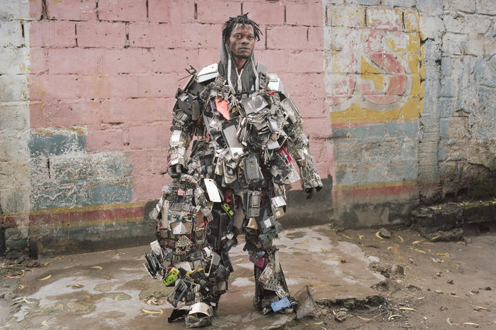 Nada Thsibwabwa poses in a robot-like costume that he created using old mobile phones, in Matonge district, Kinshasa. The country is a major producer of coltan, an ore used in cellphones and other electronics.