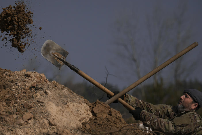 A Ukrainian serviceman digs a trench outside the capital Kyiv in March. Facing a more powerful Russian army, the Ukrainians have had to figure out ways to defend themselves. The Ukrainians have stressed basic measures, like digging deeper trenches to defend against Russian artillery, as well as high-tech methods, like using computer tablets on the battlefield to coordinate their artillery fire.