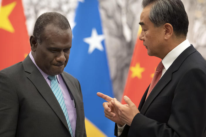 Solomon Islands Foreign Minister Jeremiah Manele, left, and Chinese Foreign Minister Wang Yi talk during a ceremony to mark the establishment of diplomatic relations between the Solomon Islands and China at the Diaoyutai State Guesthouse in Beijing on Sept. 21, 2019.