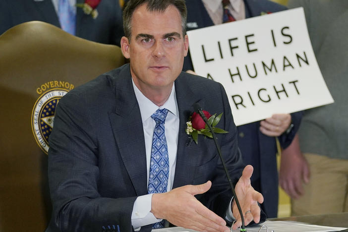 Oklahoma Gov. Kevin Stitt speaks after signing into law a bill making it a felony to perform an abortion, punishable by up to 10 years in prison, on April 12, 2022, in Oklahoma City.