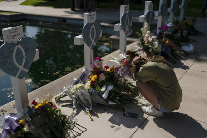 Elena Mendoza, 18, on Thursday grieves in front of a cross honoring her cousin, Amerie Jo Garza, one of the victims killed in this week's elementary school shooting in Uvalde, Texas.