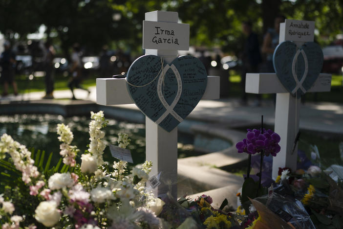 Messages are written on a cross Thursday honoring Irma Garcia, a teacher who was killed in this week's elementary school shooting, in Uvalde, Texas.