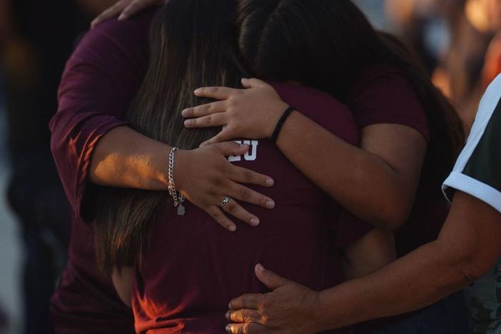People mourn Wednesday as they attend a vigil for the victims of the mass shooting at Robb Elementary School in Uvalde, Texas.