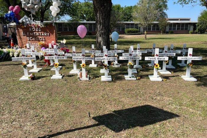 A memorial to the students and faculty who died stands in front of Robb Elementary School in Uvalde, Texas. It's not clear who put the memorial up and authorities have not released the names of the deceased.