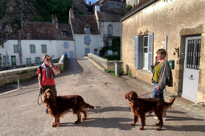 Yuri Mazurenko and Macha Levitin get ready to go on a walk with their dogs Rolly and Safra in a village in Burgundy, France.