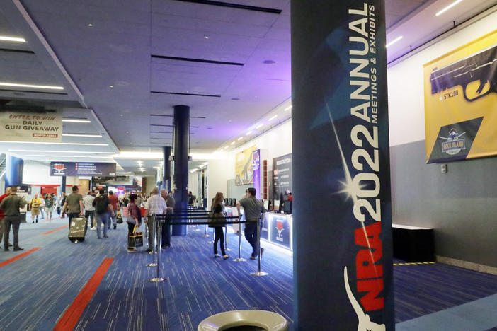 Attendees of the NRA's annual convention gather by booths in the exhibit halls of the George R. Brown Convention Center in Houston on Thursday.