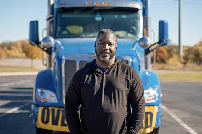 Heavy haul trucker Eric Jammer stands in front of his truck.