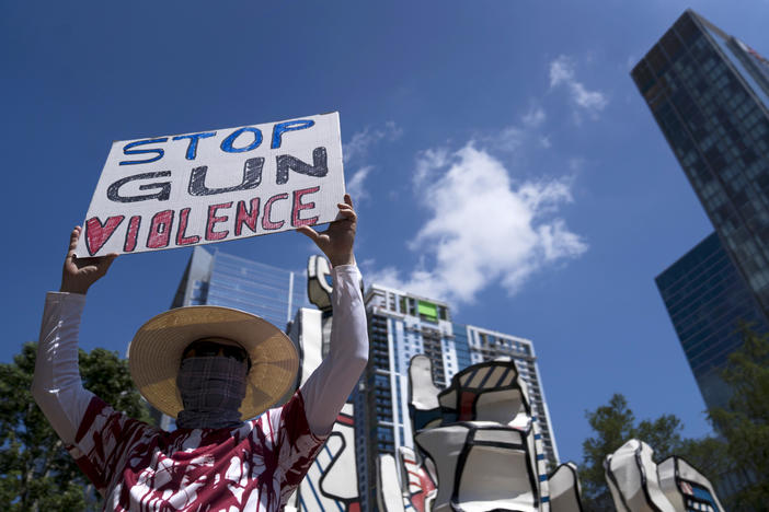 Gun control advocates hold signs during a protest at Discovery Green across from the National Rifle Association Annual Meeting at the George R. Brown Convention Center on Friday in Houston, Texas.