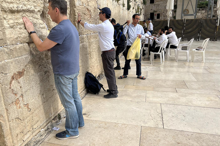 Ahmed Quraishi (second from left), a Pakistani TV news anchor, stands at the Western Wall prayer site in Jerusalem in May. His participation in the rare Pakistani visit sparked a backlash back home, prompting Pakistani state-run TV to fire him.
