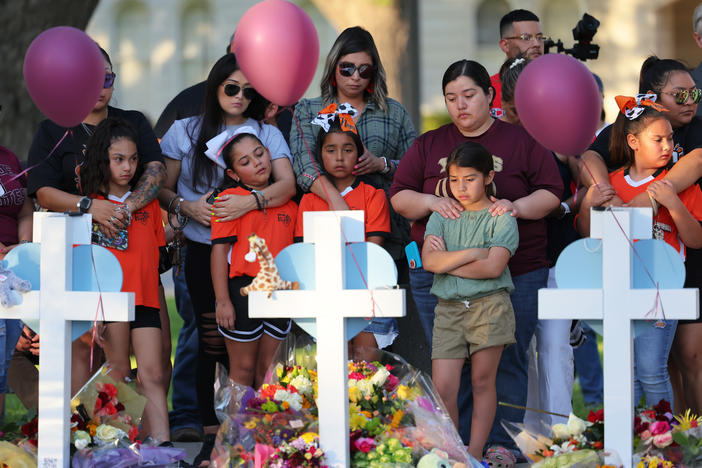People visit memorials Thursday for victims of the mass shooting at Robb Elementary School in Uvalde, Texas.
