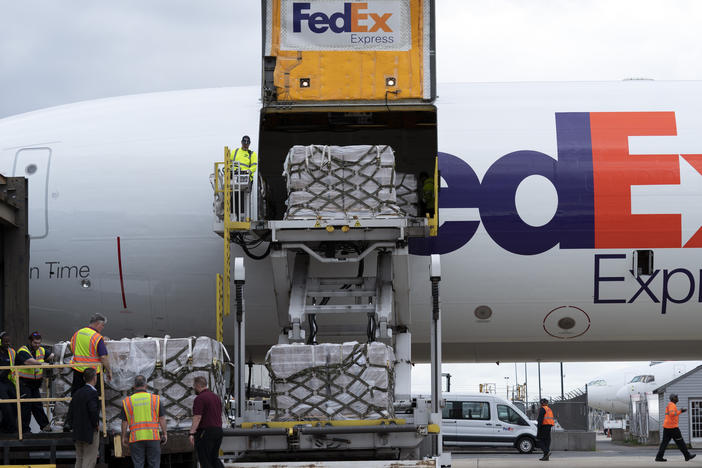 Workers unload a FedEx cargo plane carrying 100,000 pounds of baby formula at Washington Dulles International Airport, in Chantilly, Va., on Wednesday.