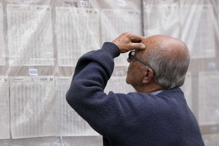 A man looks for his polling post during presidential elections in Bogota, Colombia, Sunday, May 29, 2022.