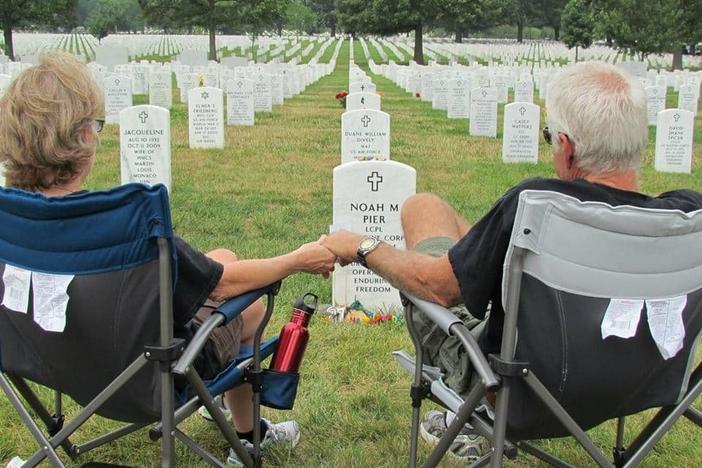 Vikki and Mark Pier visit the grave of their son, Noah, who was buried at Arlington National Cemetery in July 2011. They used to visit every few months, but they have been unable to make it in recent years.
