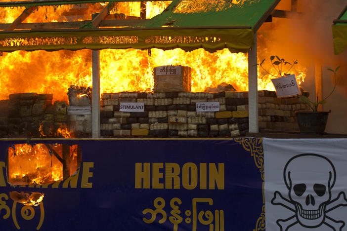 Smokes and flames billow from burning narcotic drugs during a destruction ceremony of seized narcotic drugs in outskirts of Yangon, Myanmar on June 26, 2018.