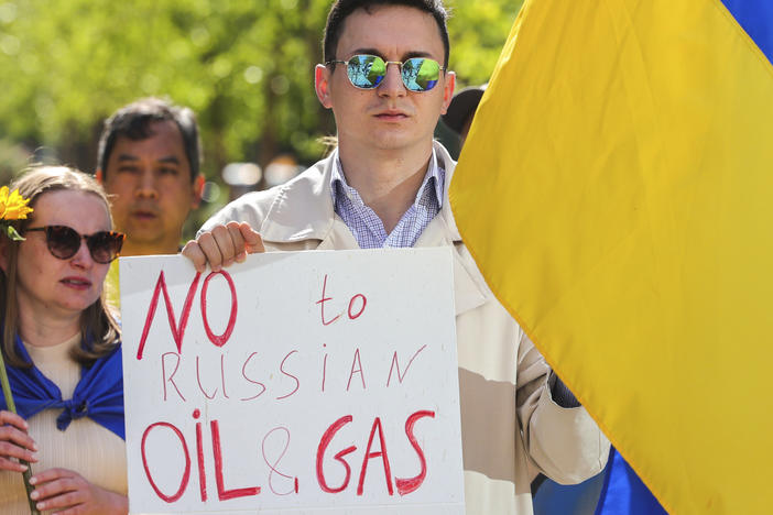 Ukrainian demonstrators demand an embargo on Russian oil during a protest in front of EU institutions prior to an extraordinary meeting of EU leaders to discuss Ukraine, energy and food security at the Europa building in Brussels on Monday.