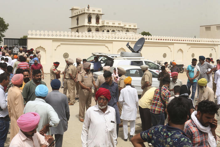 Villagers gather outside the residence of Shubhdeep Singh Sidhu, also known around the world by his stage name Sidhu Moose Wala, in a village near in Mansa, India on Monday.