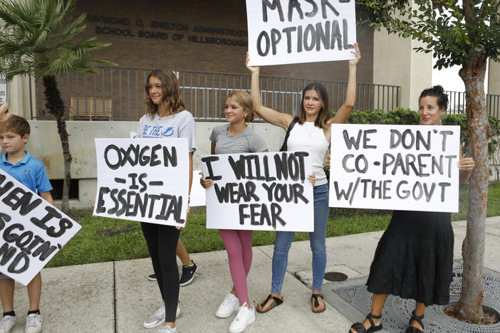 Anger over issues such as the mask mandate galvanized families — like these seen at the Hillsborough County School Board in Tampa, Fla., last year — into running for school board. Progressive groups are taking a leaf out of their playbook.