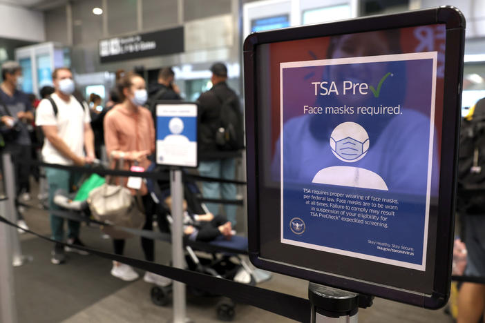 The U.S. Justice Department filed a brief in federal appeals court Tuesday to overturn a federal judge's decision that declared the government mask mandate on planes, trains and buses unlawful. Here, a sign stating that masks are required at San Francisco International Airport stands in a terminal after the federal mask mandate was overturned.