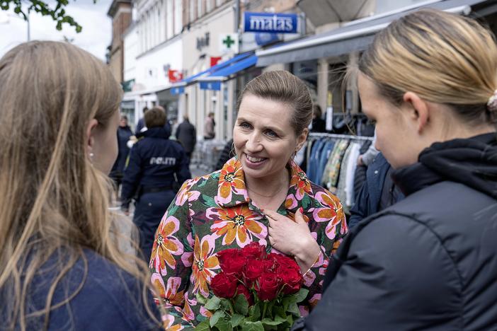 Denmark's Prime Minister Mette Frederiksen, center, speaks to people while on an election campaign, in Holbaek, Denmark, Saturday, May 28, 2022.