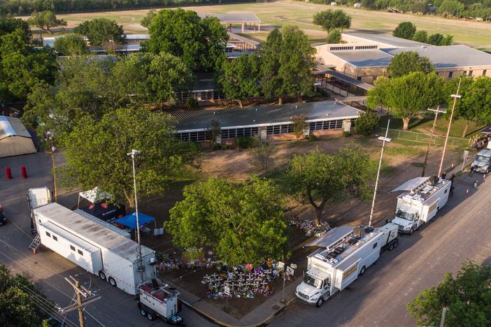 An aerial view of Robb Elementary School and the makeshift memorial for the shooting victims in Uvalde.