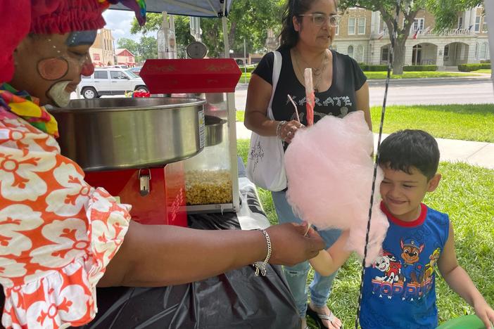 Dunbar hands cotton candy to Israel on Tuesday.