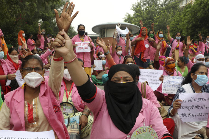 Female community health care workers protest in New Delhi, India, in August 2020. The women are part of a government program called Accredited Social Health Activists — and are demanding higher pay and better working conditions. In May, the program won an award from the World Health Organization.