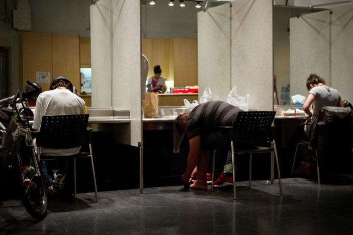 Addicts inject themselves in May 2011 at the Insite supervised injection center in Vancouver, Canada.
