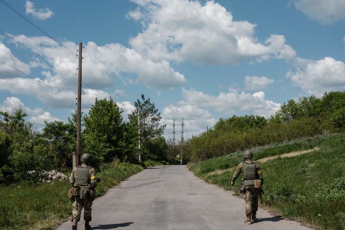 Ukrainian soldiers patrol on a road in Sydorove, eastern Ukraine, on May 17, 2022. The U.S. is sending Ukraine more advanced rocket systems and munitions in the fourth month of the war.