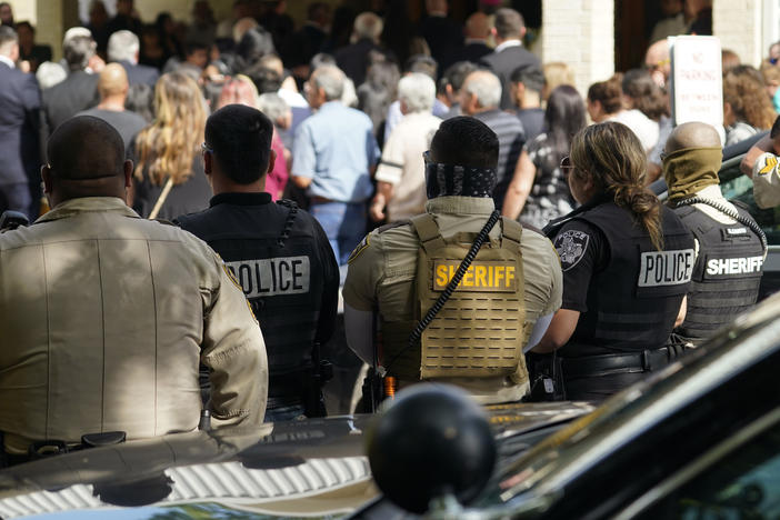 Guests arrive at the joint funeral service for Irma Garcia and her husband, Joe Garcia, at Sacred Heart Catholic Church in Uvalde, Texas, on Wednesday. Schoolteacher Irma Garcia died in the May 24 school shooting in Uvalde, and her husband died two days later of a heart attack.