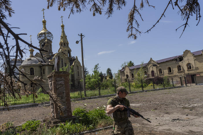 A Ukrainian serviceman patrols a village near the front line in the Donetsk oblast region, eastern Ukraine, Thursday.