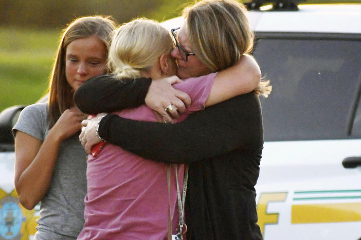 People console each other after a shooting at Cornerstone Church on Thursday, June 2, 2022 in Ames, Iowa. Two people and a shooter died Thursday night in a shooting outside a church in Ames, authorities said.