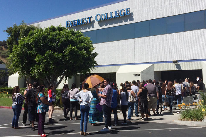 Students wait outside Everest College in Industry, Calif., in April, 2015, hoping to get their transcriptions and information on loan forgiveness and transferring credits to other schools.