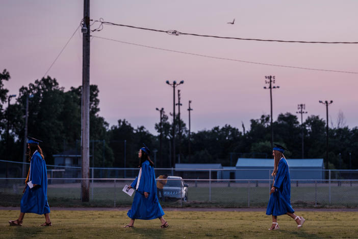 Zoe, second from left, walks onto the field with her fellow graduates. Zoey was one of eight Valedictorians and told her classmates, "Do not think about the unknown stresses of the future or the treasured memories of the past, but think about the present moment we are living right now."