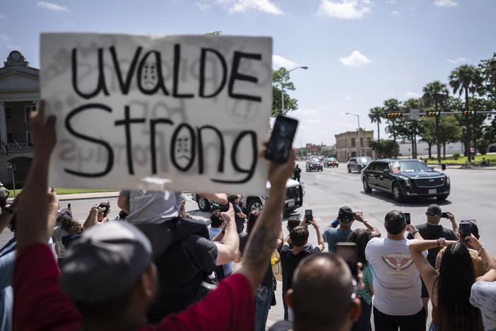 President Biden and first lady Jill Biden drive past a memorial site in the town square of Uvalde set up for those killed in the school mass shooting, on their way to Robb Elementary School on Sunday in Uvalde, Texas.