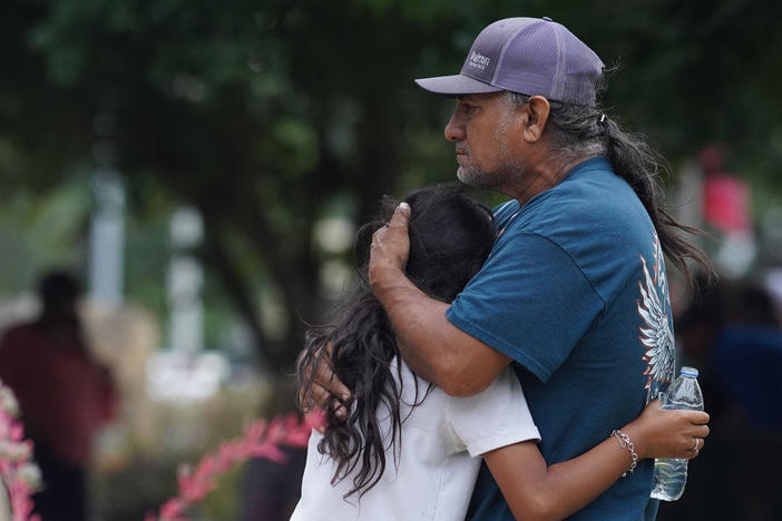 Families hug outside the Willie de Leon Civic Center where grief counseling will be offered in Uvalde, Texas, on May 24.