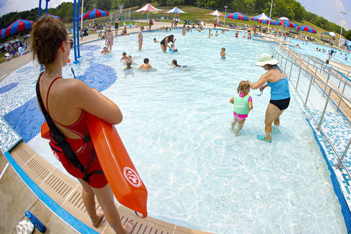 Lifeguard Maggie Storti (left) keeps an eye on visitors to the North Boundary Park swimming pool and waterpark on July 9, 2020, in Cranberry Township, Pa.