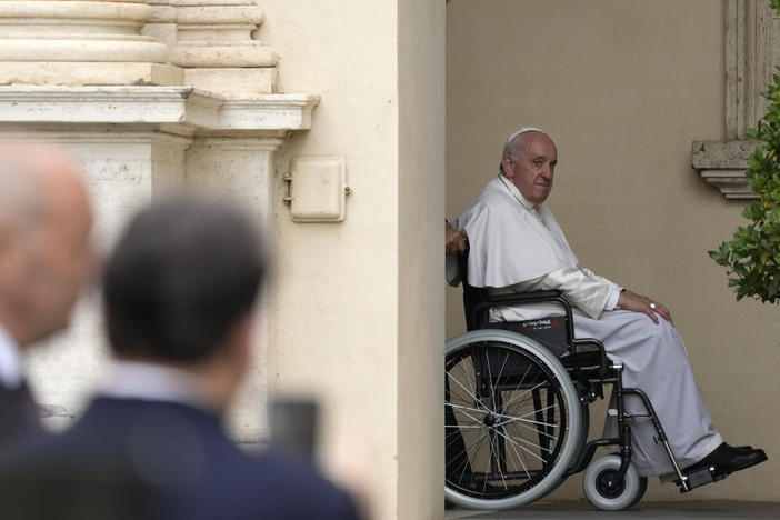 Pope Francis arrives on a wheelchair for an audience with children in the San Damaso courtyard at the Vatican, June 4, 2022.