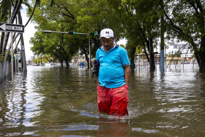 A man crosses the flooded intersection in the Little Havana neighborhood of Miami on Saturday.