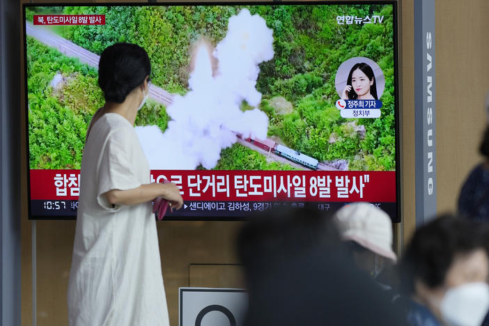 People watch a TV screen showing a news program reporting about North Korea's missile launch with file footage, at a train station in Seoul, South Korea, on June 5, 2022. North Korea test-fired a salvo of multiple short-range ballistic missiles toward the sea on Sunday, South Korea's military said.