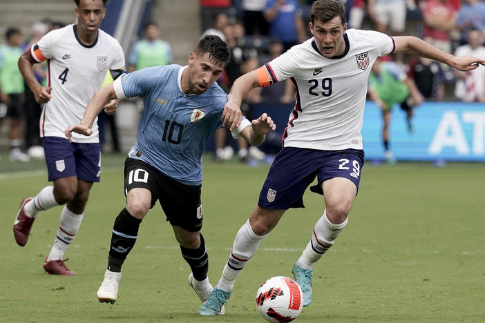 Uruguay midfielder Fernando Gorriaran and U.S. defender Joe Scally chase the ball during the first half of an international friendly soccer match on Sunday in Kansas City, Kan.