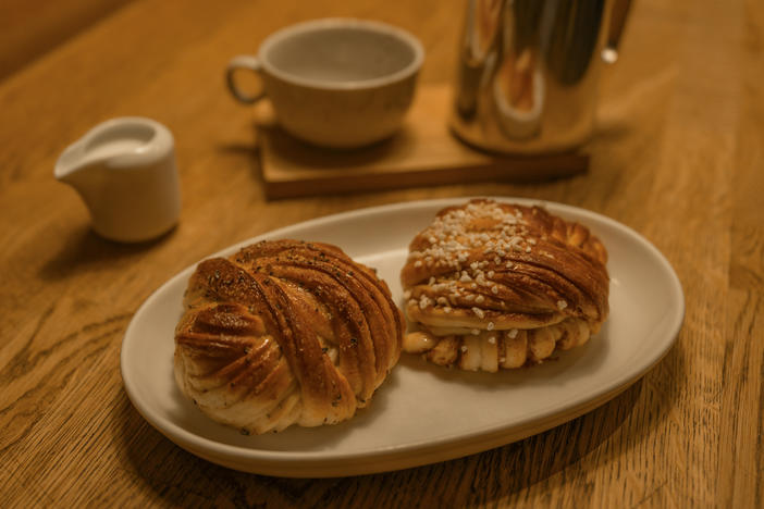 Cinnamon and cardamon bun served in a Swedish cafe, often eaten at <em>fika </em>– a Swedish word that's often translated as "coffee and cake break." <em></em>