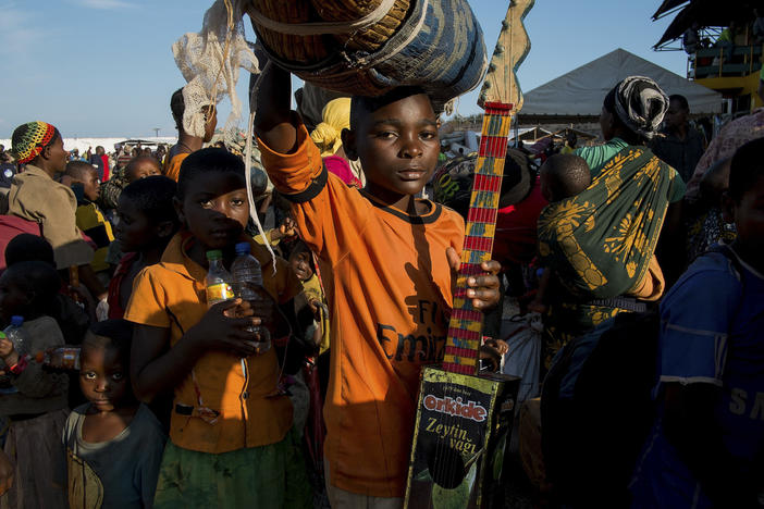 Burundian refugee Richard Samuel, 14, holds his homemade guitar as he waits to be transferred to Nyarugusu refugee camp in Tanzania in 2015.