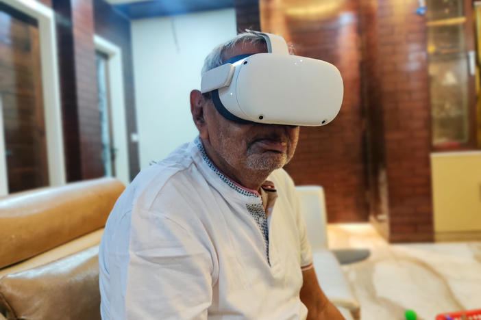 Ishar Das Arora, 83, watches a 3-D video of his birthplace in Pakistan, through a virtual reality device.