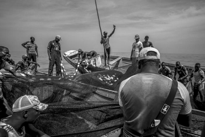 Fishermen haul in a fishing net in the eastern central Atlantic off Senegal. Belgian photographer Pierre Vanneste documents commercial fishing in his black-and-white photos.