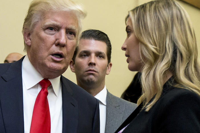 Donald Trump, left, his son Donald Trump Jr., center, and his daughter Ivanka Trump speak during the unveiling of the design for the Trump International Hotel in Washington, on Sept. 10, 2013.