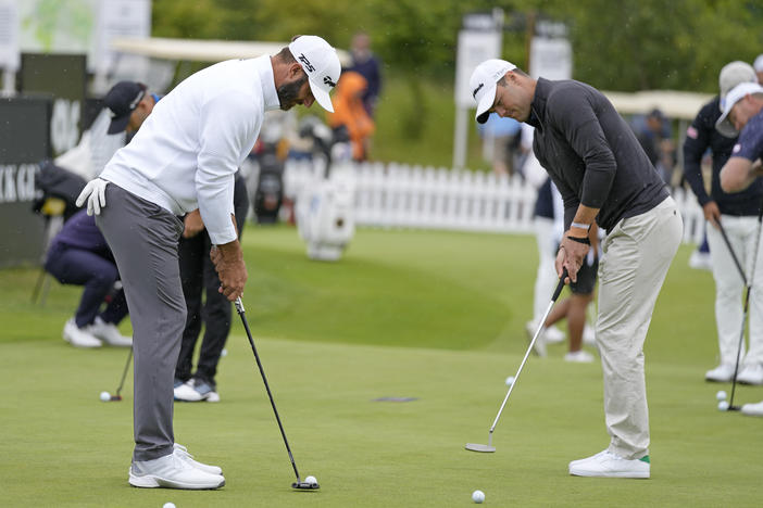 Dustin Johnson of the United States, left, and Martin Kaymer of Germany on the practice green before the first round of the inaugural LIV Golf Invitational at the Centurion Club in St. Albans, England, on Thursday.